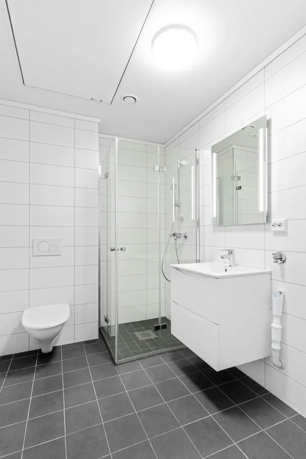Clean white tiled bathroom