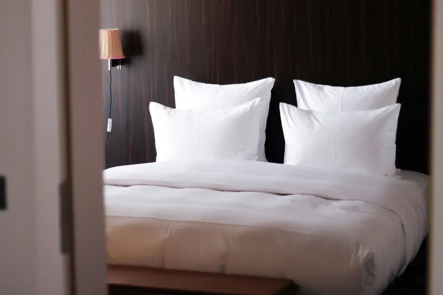 Hotel bed with fresh white linen